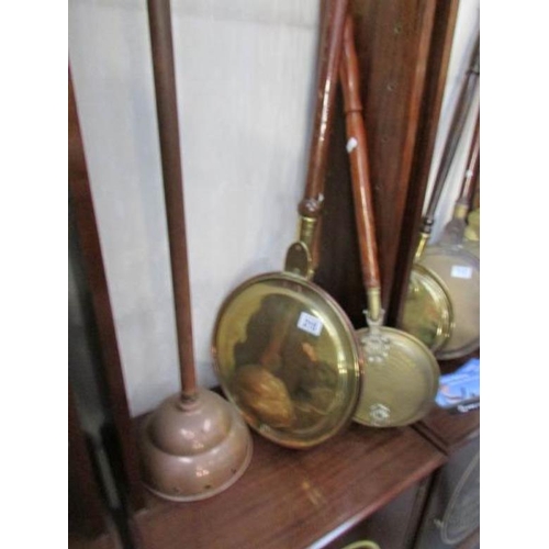 215 - A large copper and brass warming pan, 2 smaller warming pans and a washing dolly