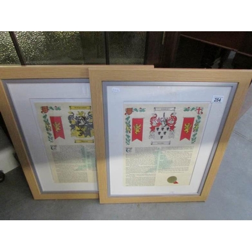 284 - A pair of framed and glazed family crests