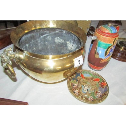 9 - An Indian brass elephant handled pot, a Japanese coffee pot and saucer