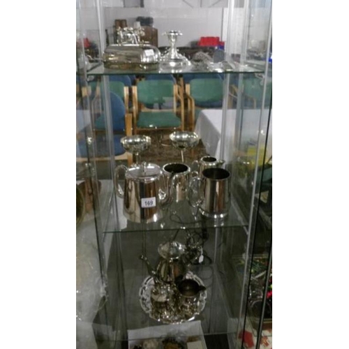 169 - A good mixed lot of silver plate including tea sets, utensils etc (3 shelves in cabinet)