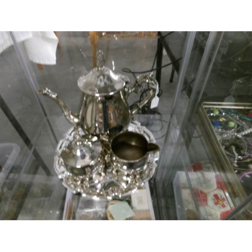 169 - A good mixed lot of silver plate including tea sets, utensils etc (3 shelves in cabinet)