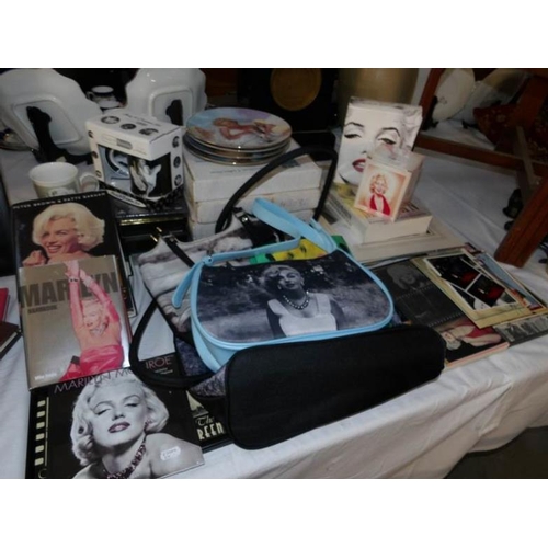 243 - A large collection of Marilyn Monroe memorabilia including CD's, Calendars, books, bags, plates etc