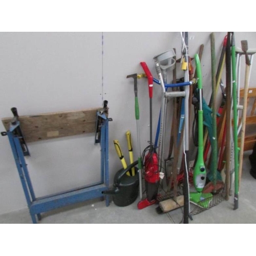 8 - A good lot of garden tools, workbench etc