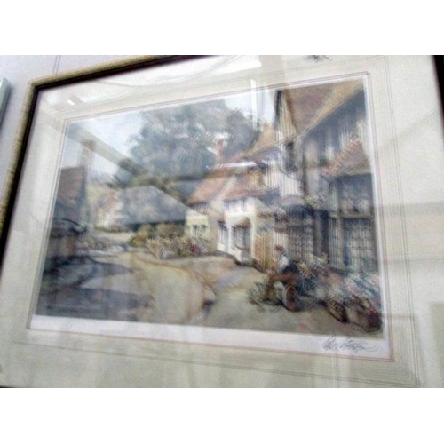 645 - A framed and glazed street scene print and a framed and glazed print of a seated lady