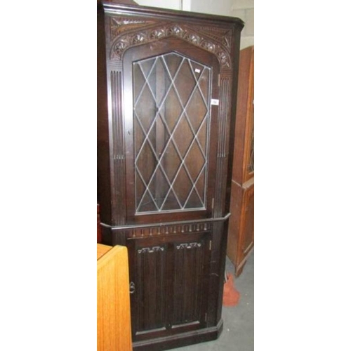 54 - An oak lead glazed corner cabinet