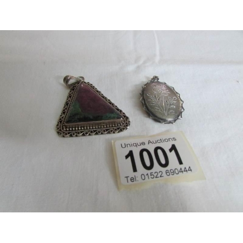 1001 - A silver locket and a silver amethyst pendant