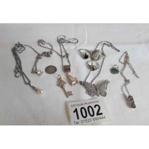 1002 - 5 silver pendants on chains, 3 rings and 3 charms