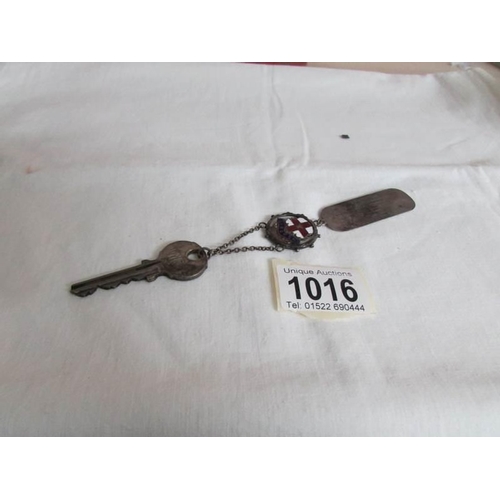 1016 - A Presentation key with silver tag, dated 1952