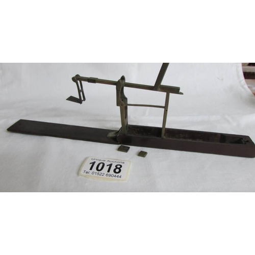 1018 - A cased set of antique guinea scales with 2 weights