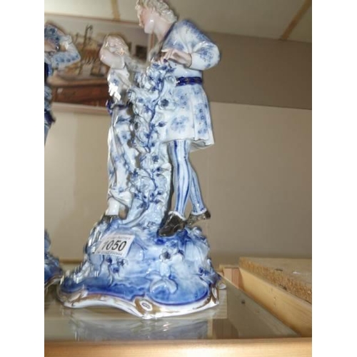 1050 - A pair of blue and white German figure groups, possibly Sitzendorf