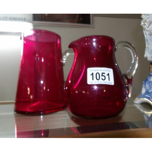 1051 - 2 cranberry glass jugs