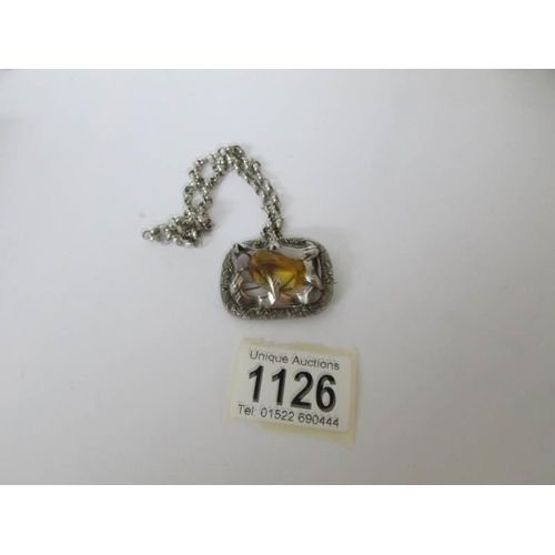 1126 - A vintage silver pendant on silver chain and set with yellow stone