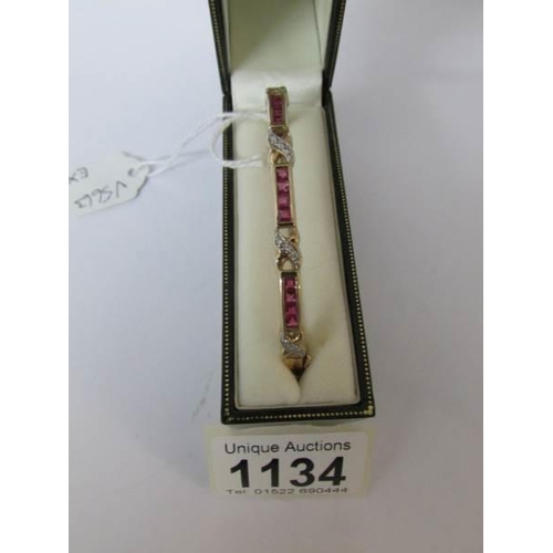 1134 - A 9ct gold bracelet with channel set diamonds and pink stones