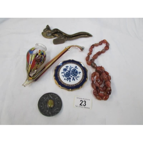 23 - A squirrel nut cracker, a glass pipe, a Stratton powder compact, a necklace and a brooch