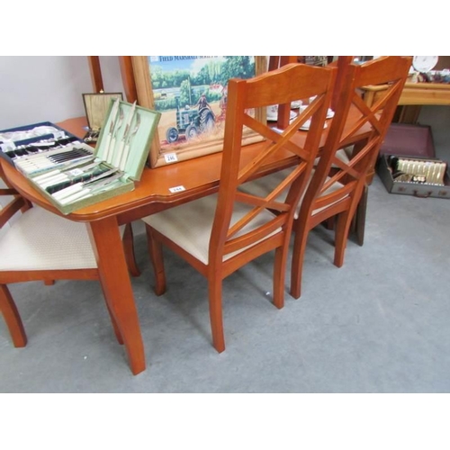 244 - A teak table and 6 chairs