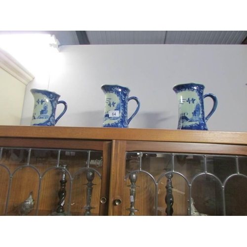 64 - A set of 3 blue willow pattern jugs, one a/f