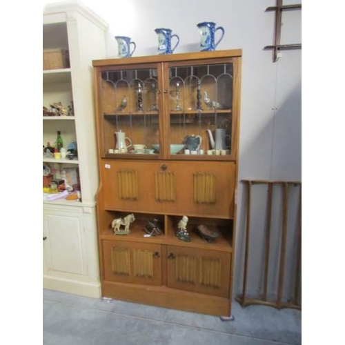 68 - A teak cabinet with lead glazed doors