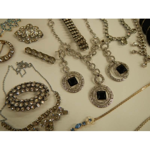 1 - A mixed lot of costume jewellery including necklaces, bracelets, brooches etc.,