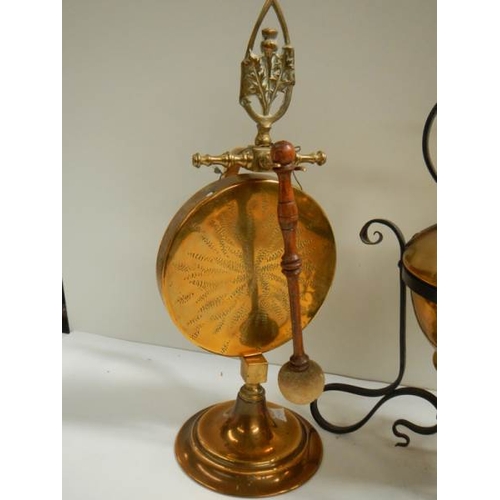 100 - A Victorian brass kettle on stand and an early 20th century brass dinner gong.