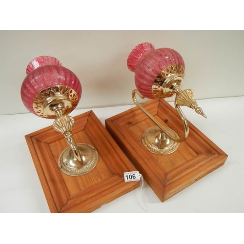 106 - 2 vintage bedside wall lamps with red shades.