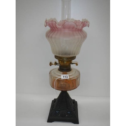 113 - A good Victorian oil lamp with cranberry tint to shade.