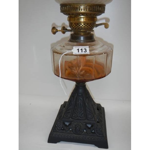 113 - A good Victorian oil lamp with cranberry tint to shade.