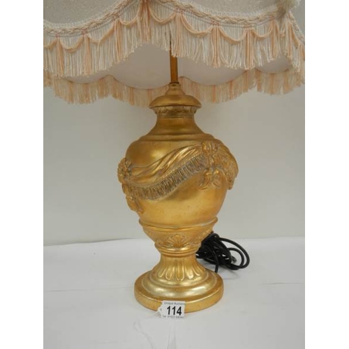 114 - A good modern gilded table lamp with fringed shade, 28'' tall.