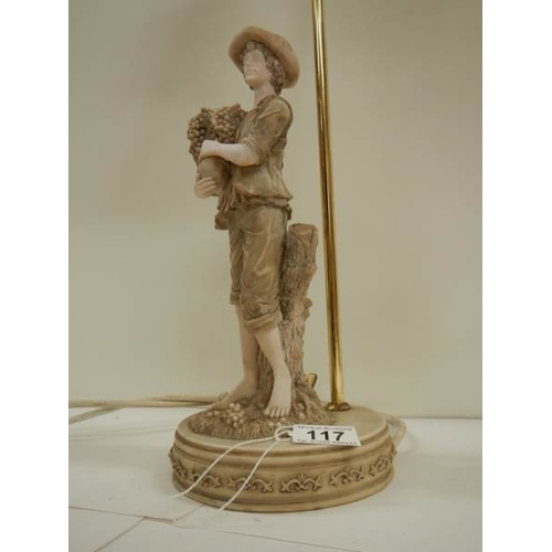 117 - A mid 20th century table lamp surmouted fruit picker, 23'' tall.