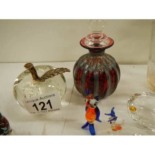 121 - A mixed lot of glass including scent bottles, paperweight, animals etc.,