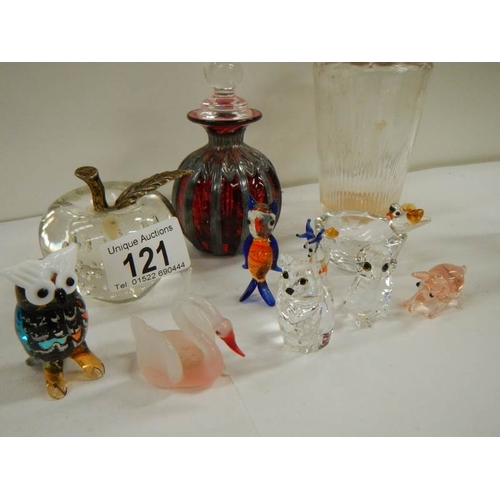 121 - A mixed lot of glass including scent bottles, paperweight, animals etc.,