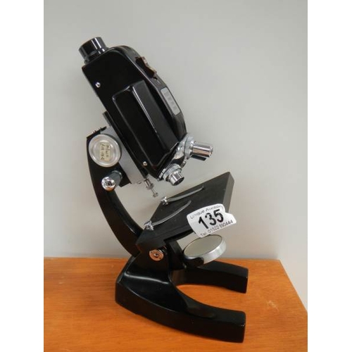 135 - A model E power zoom microscope.