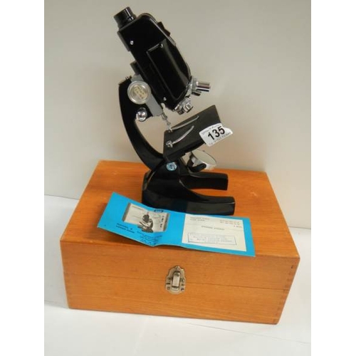 135 - A model E power zoom microscope.