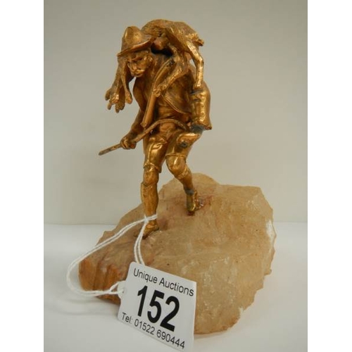 152 - A small gilded figure of a mountain goat farmer standing on a rock, 5.5'' tall.