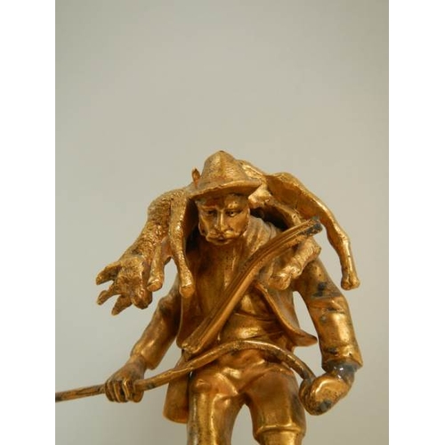 152 - A small gilded figure of a mountain goat farmer standing on a rock, 5.5'' tall.