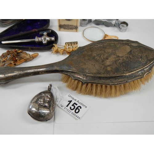 156 - A mixed lot of interesting items including silver rattle, brush etc.,