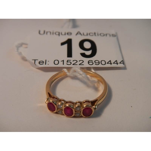 19 - An 18ct gold diamond and ruby ring, Size M (box not included)