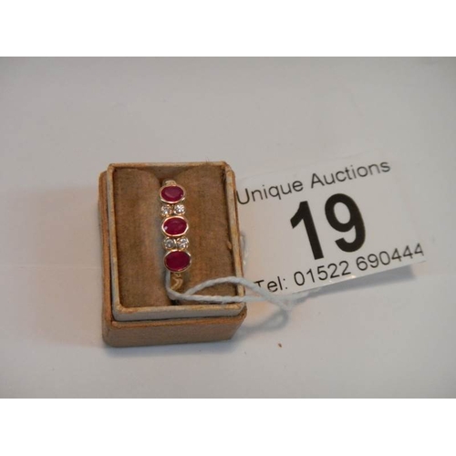 19 - An 18ct gold diamond and ruby ring, Size M (box not included)