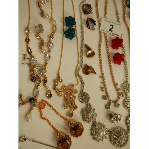 2 - A mixed lot of costume jewellery including necklaces, earrings, brooches etc.,