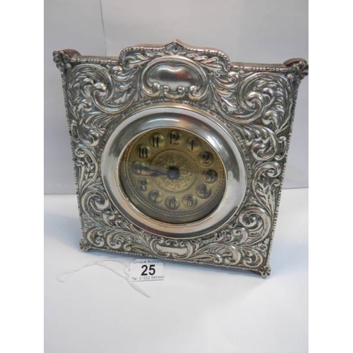 25 - A good quality embossed silver plated mantel clock in good working order (8'' wide x 8'' high).