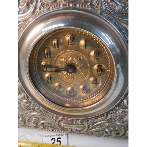 25 - A good quality embossed silver plated mantel clock in good working order (8'' wide x 8'' high).