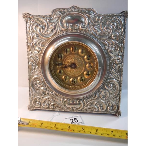 25 - A good quality embossed silver plated mantel clock in good working order (8'' wide x 8'' high).