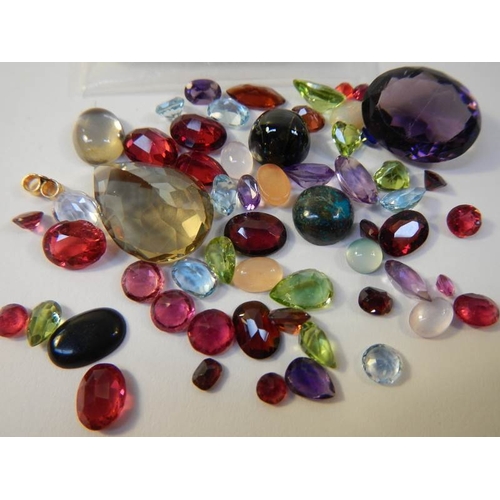 45 - A mixed lot of loose gem stones including rubies, approximately 50 in total.