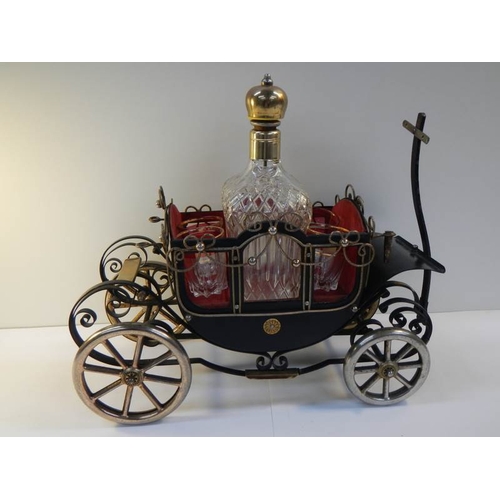 46 - A 1950's musical.decanter stand in the form of a carriage complete with decanter and 4 glasses.