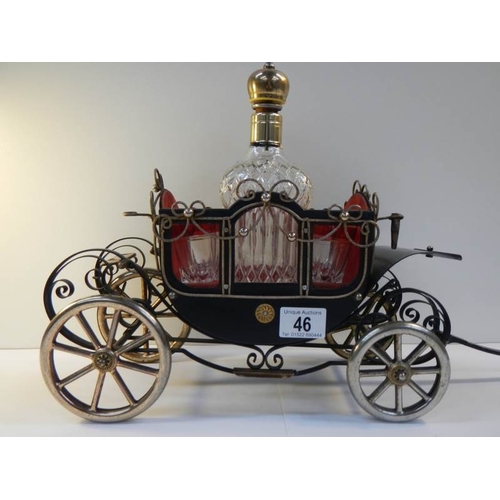 46 - A 1950's musical.decanter stand in the form of a carriage complete with decanter and 4 glasses.