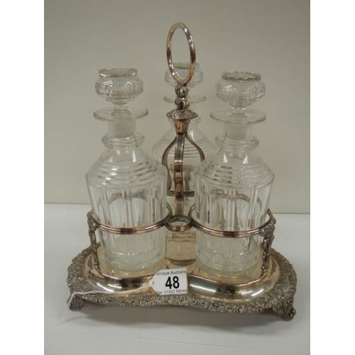 48 - A Victorian 3 bottle tantalus complete with decanters, in good condition.