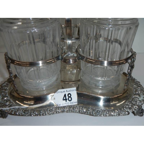 48 - A Victorian 3 bottle tantalus complete with decanters, in good condition.