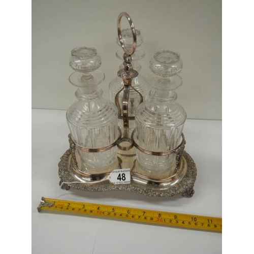 48 - A Victorian 3 bottle tantalus complete with decanters, in good condition.