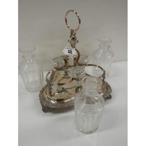 48 - A Victorian 3 bottle tantalus complete with decanters, in good condition.