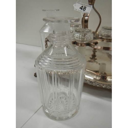 48 - A Victorian 3 bottle tantalus complete with decanters, in good condition.