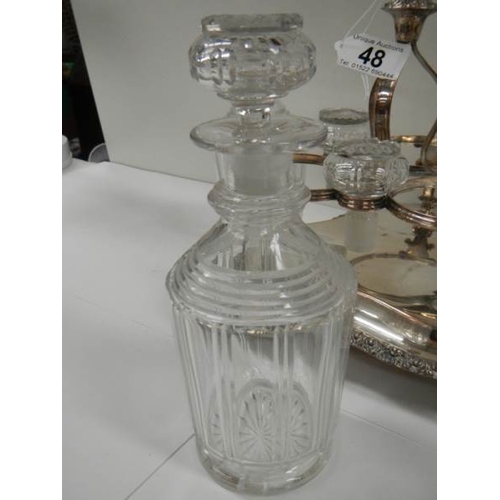 48 - A Victorian 3 bottle tantalus complete with decanters, in good condition.